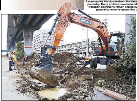  ?? BOY SANTOS ?? A backhoe clears the center island on EDSA in Caloocan City yesterday to give way for bus loading and unloading stops at the MRT and LRT stations. Under a new transport scheme, bus lanes will be moved from the outermost to the innermost lane, leaving the center lanes of EDSA to private cars and the outer lane for bicycles.