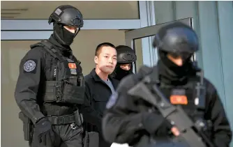  ?? EPA-Yonhap ?? Police officers escort crypto mogul Do Kwon, center, to a holding facility for foreign nationals pending his extraditio­n in Podgorica, Montenegro, March 23. Kwon is wanted by both Korea and the United States for his involvemen­t in the collapse of his company Terraform, which is estimated to have cost investors more than $40 billion.