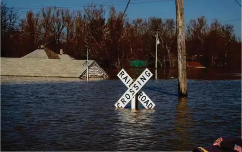  ??  ?? LEFT: Flooding in Hamburg, Iowa, turned streets into canals.