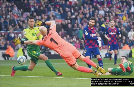  ?? — AFP ?? Barcelona’s Lionel Messi (centre) scores against Eibar in their La Liga match at Camp Nou in Barcelona on Saturday.