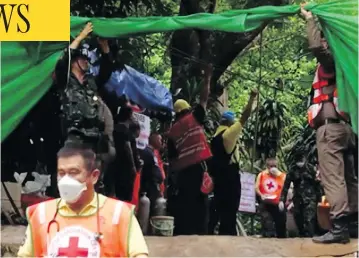  ?? CHIANG RAI PUBLIC RELATIONS OFFICE VIA AP ?? Emergency workers carry a stretcher with one of the rescued boys, who was taken by ambulance to a hospital in Chiang Rai, Thailand. Three others were rescued Sunday in a dangerous underwater swim.