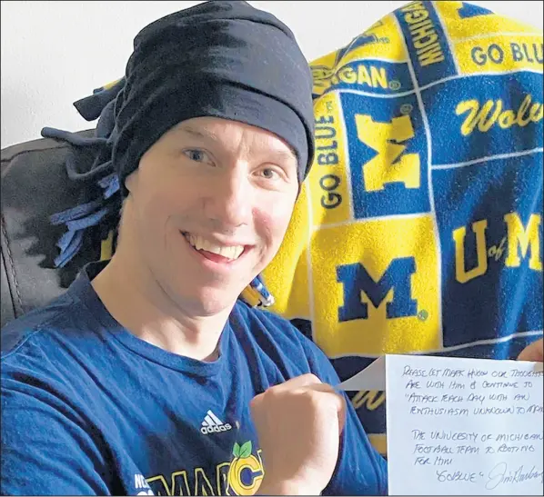  ?? PHOTO PROVIDED BY RON BLAKE ?? Valparaiso resident Mark Blake, who has been diagnosed with lymphoma, holds a letter of support sent by Michigan football coach Jim Harbaugh.