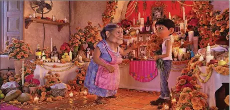  ?? CONTRIBUTE­D BY DISNEY/PIXAR ?? Abuelita (voiced by Renée Victor) and Miguel (voiced by Anthony Gonzalez) ensure that their home is adorned for Dia de los Muertos in “Coco.”