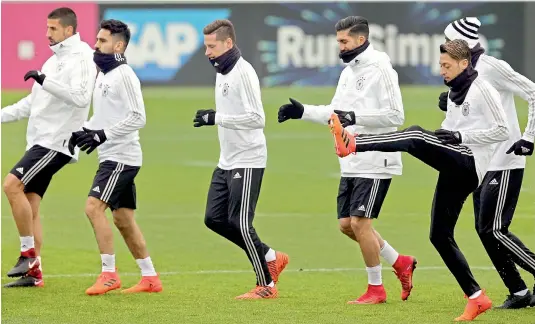  ?? — AP ?? Germany’s Mesut Ozil (right) trains with teammates at a practice session in Berlin on Thursday, eve of their friendly match against England.