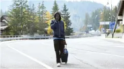  ?? (Massimo Pinca/Reuters) ?? A MIGRANT walks next to the French border in Claviere, Italy.