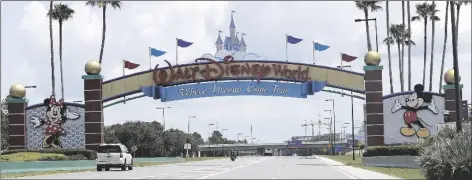  ?? JOHN RAOUX/AP ?? CARS DRIVE UNDER A SIGN GREETING VISITORS near the entrance to Walt Disney World on July 2, 2020 in Lake Buena Vista, Fla.