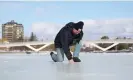  ?? Photograph: Dave Chan/AFP/Getty Images ?? Bruce Devine checks the ice condition on the Rideau Canal Skateway on 8 February. This winter has brought wild and unseasonab­ly warm weather to Canada’s capital.