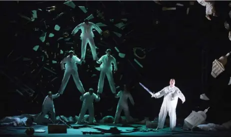  ?? TODD KOROL/TORONTO STAR ?? Six dancers form a pyramid to represent the dragon Fafner in Wagner’s Siegfried. Stefan Vinke wields his sword as Siegfried.