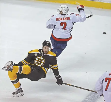  ?? STAFF PHOTO BY JOHN WILCOX ?? TRIPPED UP: Bruins forward Drew Stafford takes a tumble as Washington defenseman Matt Niskanen chases the puck during the third period of yesterday’s loss to the Capitals at the Garden.