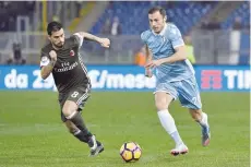  ?? — AFP ?? Lazio’s Stefan Radu (right) vies for the ball with AC Milan’s forward from Spain Fernandez Suso during the Serie A match on Monday, at Rome’s Olympic stadium.