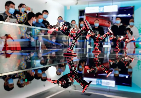  ??  ?? Artificial intelligen­ce has developed quickly in recent years in China. Visitors watch a dance performanc­e put on by a group of robots at the science and technology museum in Baofeng County, central China’s Henan Province, on February 14, 2021.