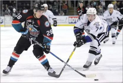  ?? GARY NYLANDER/The Daily Courier ?? Kelowna Rocket Liam Kindree, left, chases after a loose puck against Scott Walford of the Victoria Royals during first period WHL action at Prospera Place on Wednesday evening. Kelowna jumped out to a 2-0 lead, but Victoria stormed back for an 8-3 win.