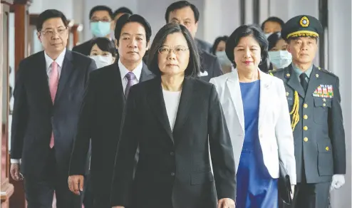  ?? Taiwan
Presidenti­al Office via AP ?? Taiwanese President Tsai Ing-wen, centre, walks ahead of Vice-president Lai Ching-te, left, as they
attend an inaugurati­on ceremony in Taipei on Wednesday. Tsai was sworn in for a second term.