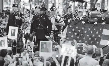  ?? EVAN VUCCI AP ?? Members of the New York Police Department Pipes and Drums perform during a ceremony marking the 20th anniversar­y of the Sept. 11, 2001, terrorist attacks Saturday at the National September 11 Memorial and Museum in New York.