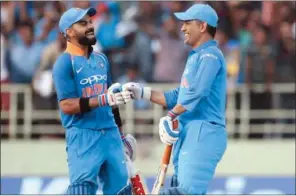  ??  ?? India skipper Virat Kohli with Mahendra Singh Dhoni during a One-Day Internatio­nal match.