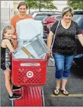  ?? JEREMY WADSWORTH / THE (TOLEDO) BLADE ?? Incoming Bowling Green State University freshman Heather Lammers of Leipsic, shops for supplies for her dorm room with her mother, Christa Lammers, and her sister Samantha.