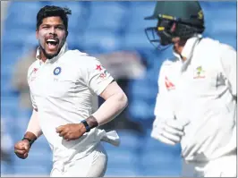  ??  ?? India's Umesh Yadav (L) celebrates after the dismissal of Australia's Nathan Lyon (R).