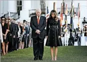  ?? WIN MCNAMEE/GETTY ?? President Donald Trump, wife Melania and the White House staff observe a moment of silence on Monday.
