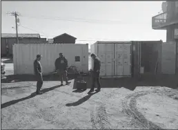  ?? Photo by Peter Loewi ?? BIKE SHOP—Jeff Collins, Nome Youth Bike Shop’s James Ventress, and Susitna Bike Institute’s Charlie Lowell discuss bike repairs standing on the future site of the permanent bike shop. The shop is currently the open container behind them.