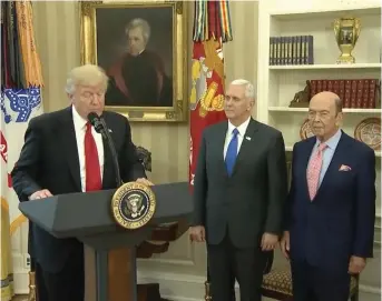  ?? White House photo ?? President Trump announces executive orders on trade on March 31, with Vice President Mike Pence and Commerce Secretary Wilbur Ross.