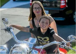  ?? PHOTO: DAVID UNWIN/ STUFF ?? Sarah Blythe and son Neko, 6, who is on the autism spectrum. Blythe raised $7000 in March from a motorbike ride to help people understand the complexiti­es behind autism. It paid for 34 Manawatu¯ teachers to attend a course run by Altogether Autism.