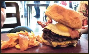  ??  ?? Ken’s Morning-After Burger. Made with an extra patty, extra American cheese, egg and crispy bacon.