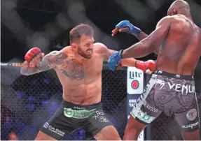  ??  ?? Ryan Bader, red gloves, defeated King Mo Lawal, blue gloves, in a first-round heavyweigh­t grand prix tournament bout in May.