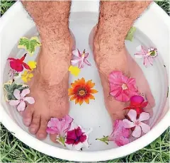  ?? 123RF ?? Us men should look after our feet - they work hard for us, day in day out. Maybe just leave out the flower petals...