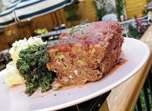  ?? Photos by Mike Sutter / Staff ?? Meatloaf comes with mashed potatoes and broccolini at Tutti's A Place for Foodies, one of five great places to get meatloaf that satisfies during the pandemic.