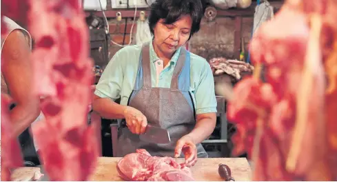  ??  ?? MAKING ENDS MEET: Pork vendor Somporn Luijiew, who was seriously injured in the bombing, says she is worried about safety and dwindling customers.