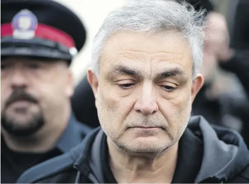  ?? PHOTOS: PETER J THOMPSON / NATIONAL POST ?? Vahe Minassian, the father of the man accused in Monday’s van rampage, is escorted by Toronto police from the courthouse on Tuesday after his son Alek’s first court appearance.