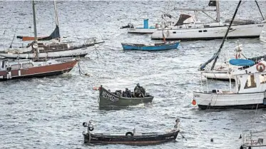 ?? FINBARR O'REILLY/THE NEW YORK TIMES PHOTOS ?? A small fishing boat transports Moroccan migrants Nov. 26 to the port of Arguineguí­n on Grand Canary Island.