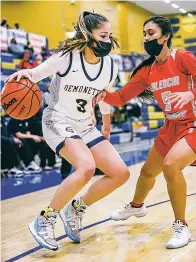  ?? GABRIELA CAMPOS/THE NEW MEXICAN ?? Santa Fe High’s Maci Cordova looks for an opening against Valencia’s defense Friday in the Bobby Rodriguez Capital City Tournament at Toby Roybal Memorial Gymnasium. The Demonettes lost the semifinal game 45-36.