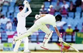  ?? FILE ?? England’s captain Joe Root (right) steals a run against the West Indies, whose wicketkeep­er Shane Dowrich looks on, during day three of the third Test match at the Daren Sammy Cricket Ground in Gros Islet, St Lucia, on February 11, 2019.