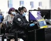  ?? DAVID SANTIAGO dsantiago@miamiheral­d.com ?? A TSA worker at Miami Internatio­nal Airport on Nov. 22, 2020. The TSA has said that fewer guns are being found in passengers’ carry-on luggage but that one is too many.