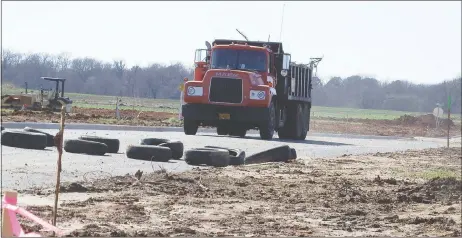  ?? TIMES photograph by Annette Beard ?? A truck hauls debris on Elkhorn Ridge subdivisio­n, the final plat of which was tabled at a special Planning Commission meeting Monday night.