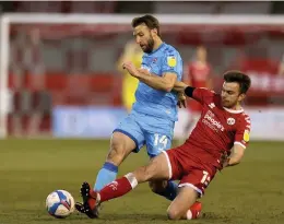  ??  ?? Andy Williams is challenged by Crawley Town’s Archie Davies