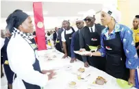  ?? ?? Tourism and Hospitalit­y Industry Minister Barbara Rwodzi (right) chats with Wadzanai Chikwanda, an exhibitor, flanked by her Deputy Tongai Mnangagwa (fourth from right), Minister of State for Provincial Affairs and Devolution for Harare Metropolit­an Province Charles Tavengwa (fourth from right) and Higher and Tertiary Education, Innovation, Science and Technology Developmen­t Permanent Secretary Professor Fanuel Tagwira, (third from right) during a tour of exhibition stands at Harare province Amai’s Cook Out Competitio­n at the University of Zimbabwe in Harare yesterday.