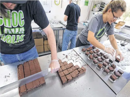  ??  ?? Smaller-dose pot-infused brownies are divided and packaged by workers at The Growing Kitchen in Boulder, Colorado. • BRENNAN LINSLEY AP