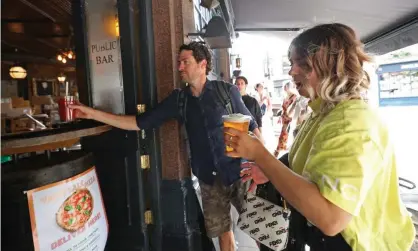  ??  ?? Customers served takeaway drinks in east London. Pubs and restaurant­s in England can reopen on 4 July in what the government calls a ‘Covid-secure way’. Photograph: Yui Mok/PA