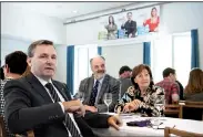  ?? AP/PETER SCHNEIDER ?? Werner Salzmann (front, left), Swiss parlamenta­rian of conservati­ve party SVP and a member of the committee against the European Union gun laws and policies, speaks at the committee’s meeting Sunday in Burgdorf, Switzerlan­d.