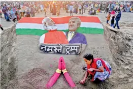  ?? PTI ?? Sand artist Laxmi Gaud creates a sculpture of Prime Minister Narendra Modi and US President Donald Trump on the eve of latter’s maiden visit to India, at Juhu Beach in Mumbai on Sunday —