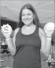  ?? MARK HUMPHREY ENTERPRISE-LEADER ?? Prairie Grove senior Mary Rush displays cupcakes bought by parents to celebrate the school hosting their firstever tennis match at the Prairie Grove tennis courts Sept. 20.