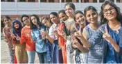  ??  ?? Students display victory sign as they pose for a photograph after the results of the Indian Certificat­e of Secondary Examinatio­n (ICSE) of class 10th and 12th were declared, in Patna on Monday