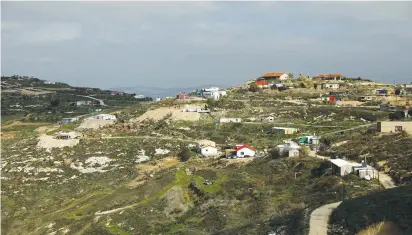  ?? (Ronen Zvulun/Reuters) ?? THE HAVAT GILAD outpost in central Samaria is shown yesterday.