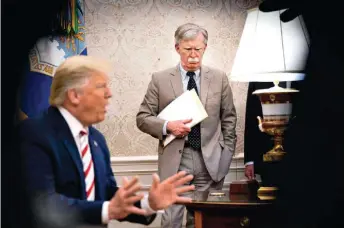  ?? ?? John Bolton looks on as President Donald Trump (left) holds a meeting in the White House, in Washington, on August 20, 2019. The veteran official expresses his concern about the former president’s possible return to power, especially regarding the future of NATO.