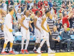  ?? EUGENE TANNER/ASSOCIATED PRESS ?? San Diego State players, and a few fans, celebrate the Aztecs’ decisive run in the second half to beat Tulsa on Friday in tournament played in Honolulu.