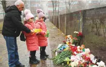  ?? Reuters ?? Tributes continued to be paid to victims next to the site of a helicopter crash, amid Russia’s attack on Ukraine, in the town of Brovary, outside Kyiv, Ukraine, yesterday. ■