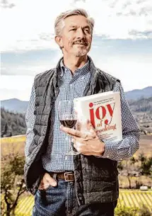  ?? Stephen Lam/The Chronicle ?? KR Rombauer, second-generation owner of Rombauer Vineyards, carries the cookbook written by his great-aunt Irma Rombauer.