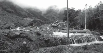  ?? ASSOCIATED PRESS ?? Rescuers use heavy equipment to search for survivors following a landslide in Sucun village in eastern China’s Zhejiang Province. Several dozen people were reported missing after rain-saturated hillsides collapsed onto villages in China following a...